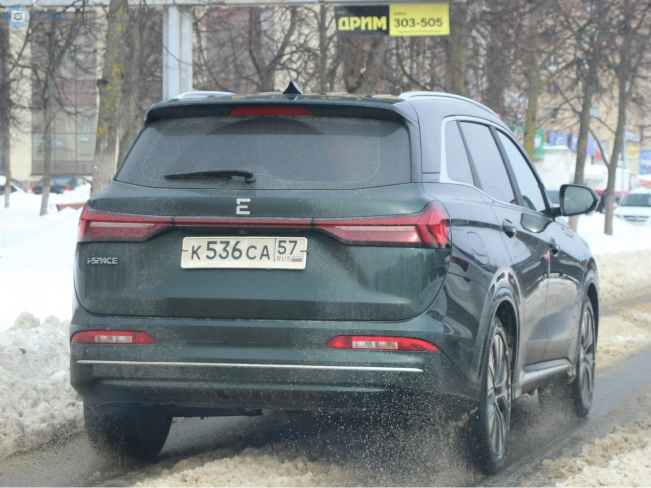 Rear view of SUV with full-width LED tail lights and roof spoiler