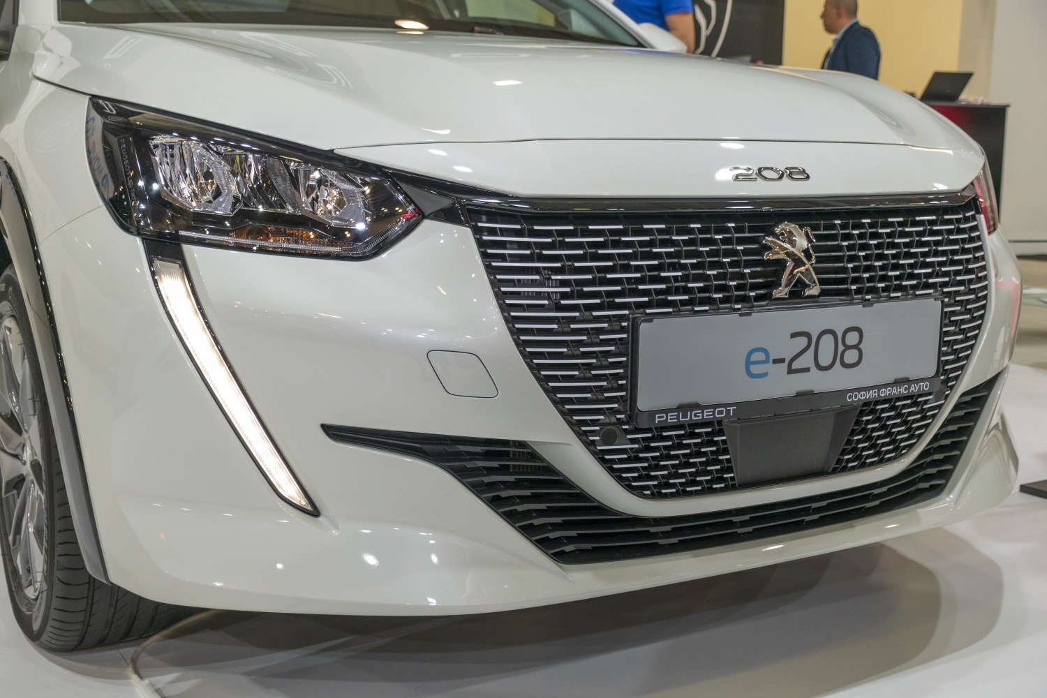 Front grille with emblem and LED headlight design