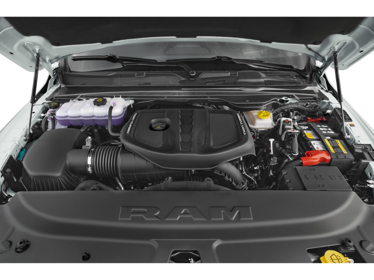 Twin turbo engine under lifted hood with detailed engine bay components.