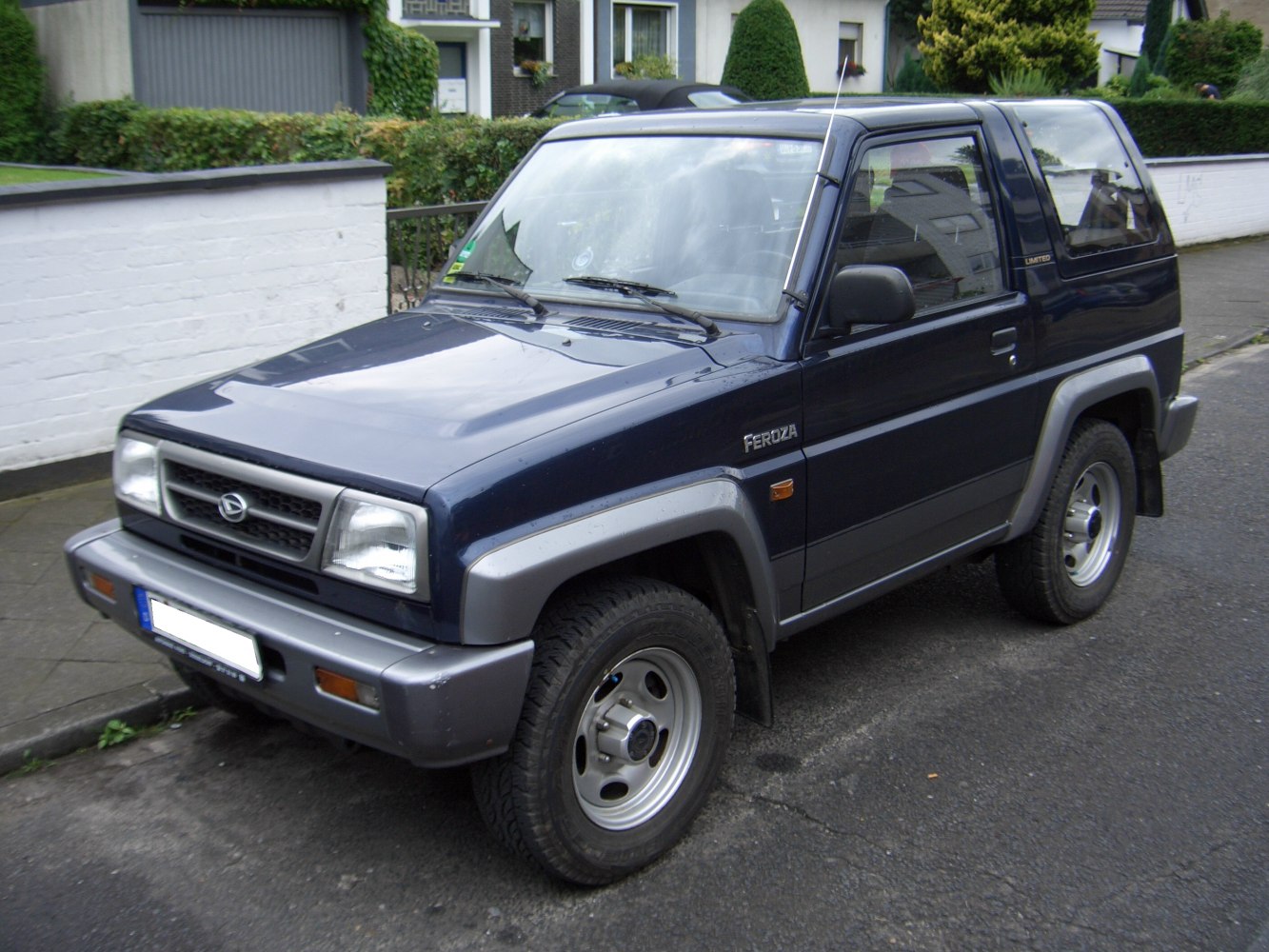 Boxy compact SUV front and side view with rugged hard top design