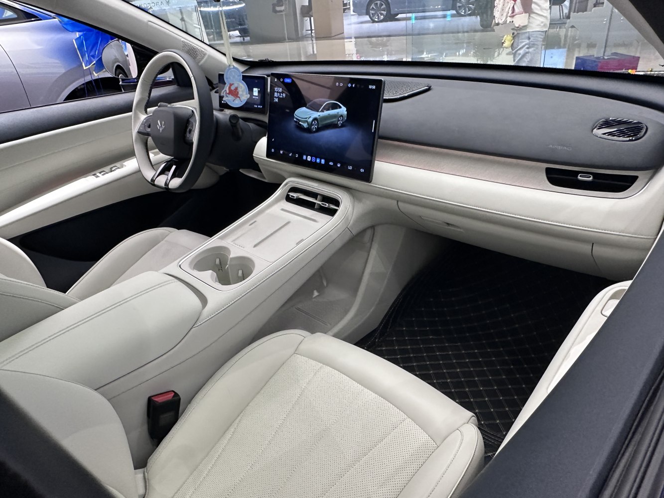 White modern car interior with large central touchscreen and minimalist design