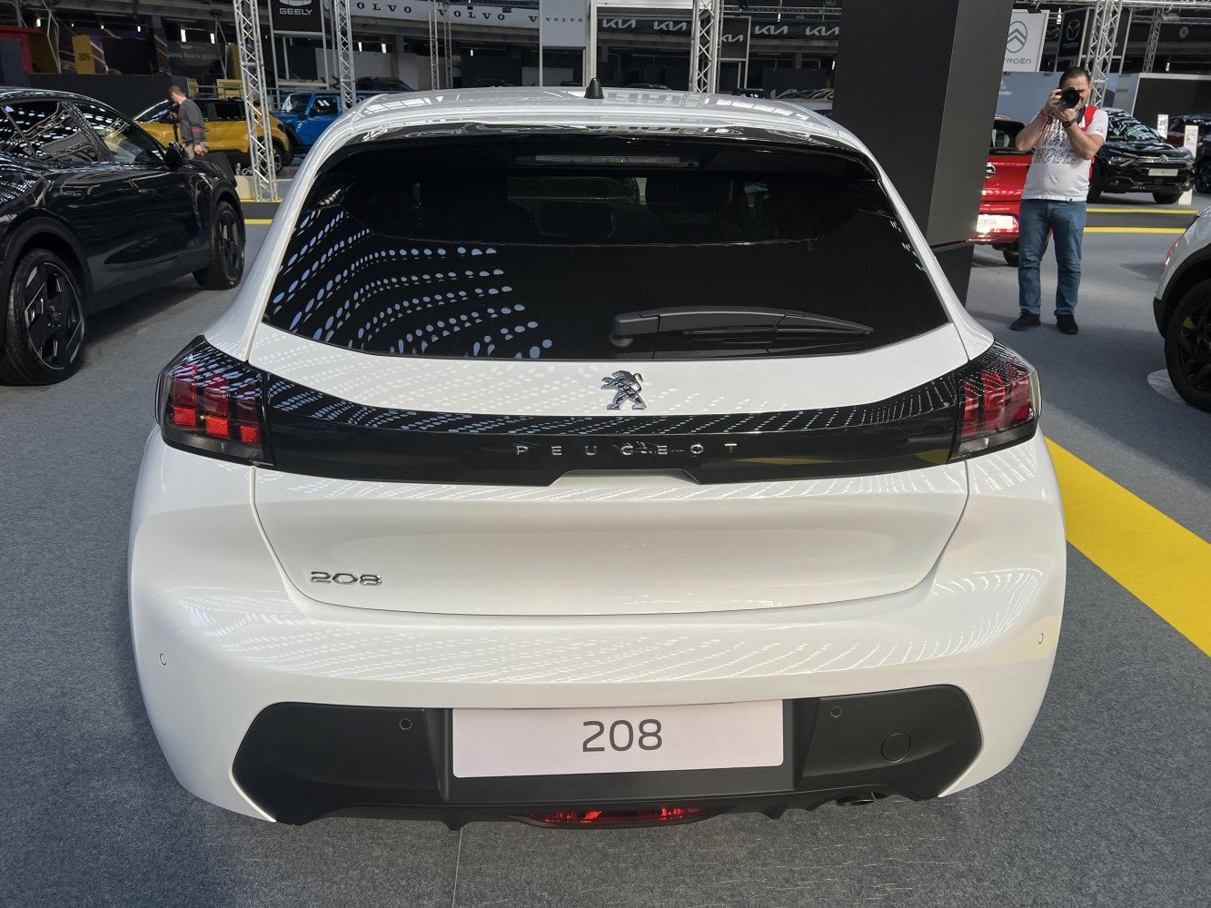 Rear hatchback view with black panel tail lights and integrated Peugeot logo.