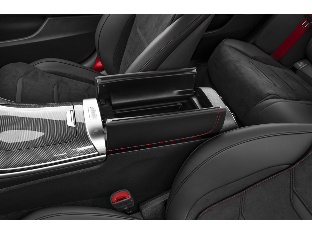 Center console storage and carbon fiber trim with red stitching in car interior