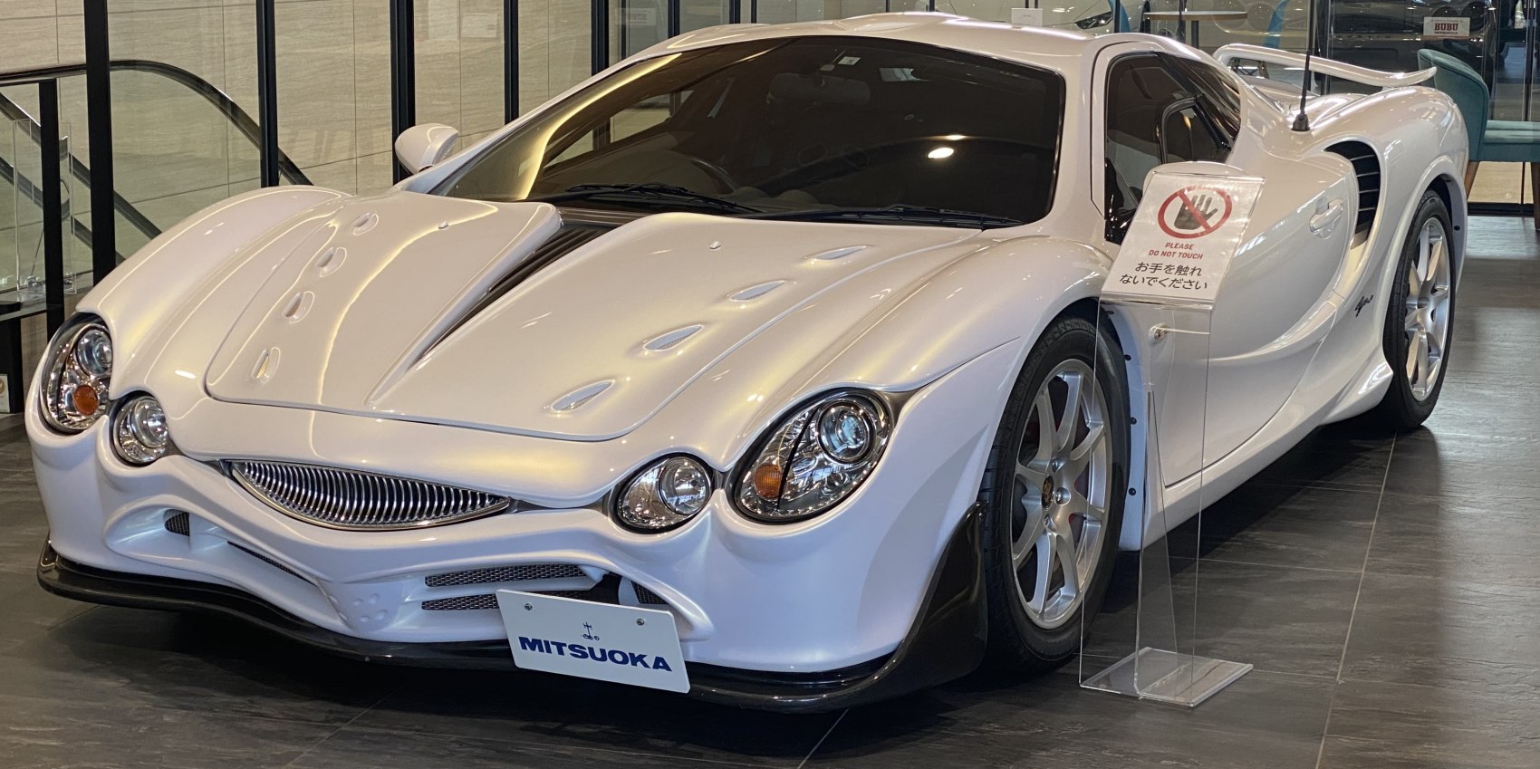 Front view with distinctive multi-lens headlights and aerodynamic hood design