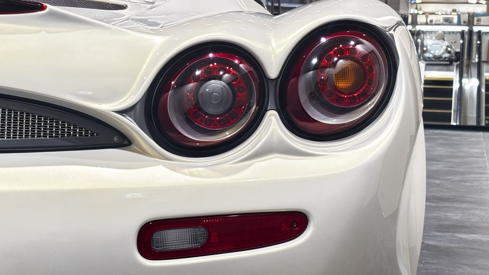 Close-up of unique circular tail light cluster with a white rear body surface