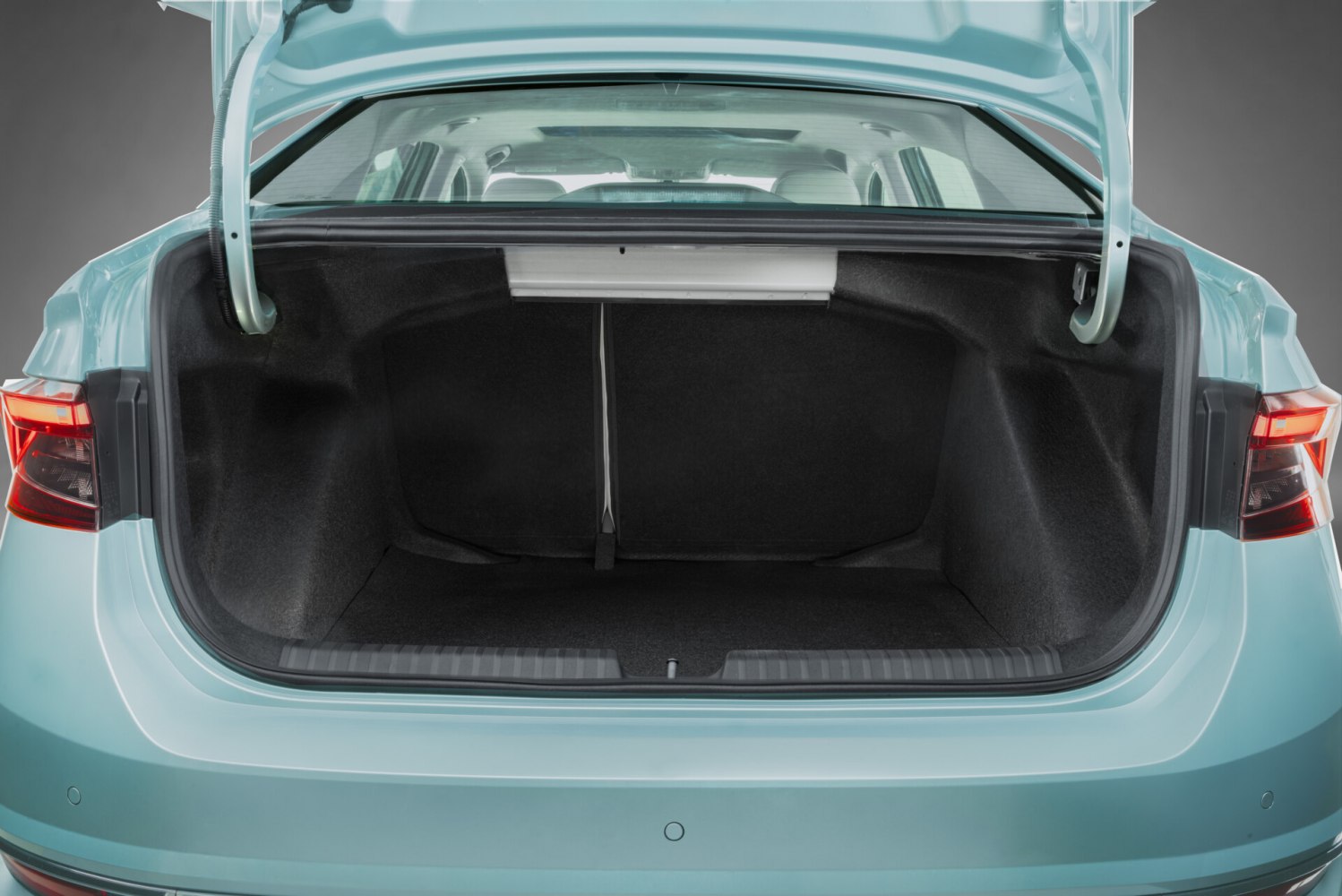 Open spacious trunk cargo area with clear interior and taillights