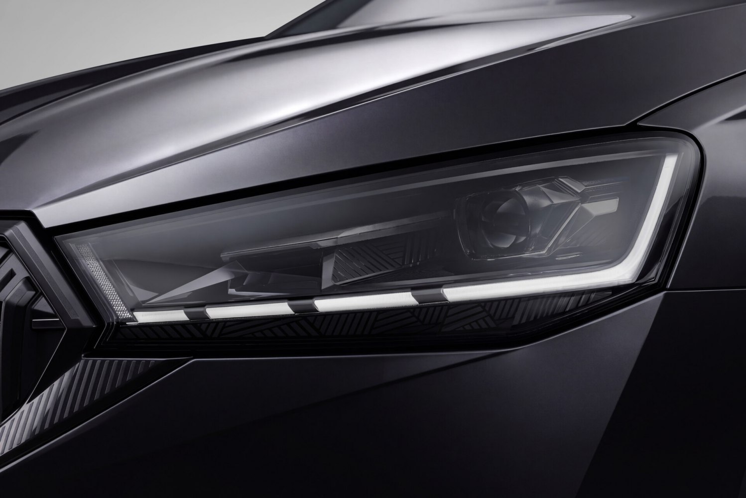 Close-up of sleek LED headlight with projector and daytime running lights