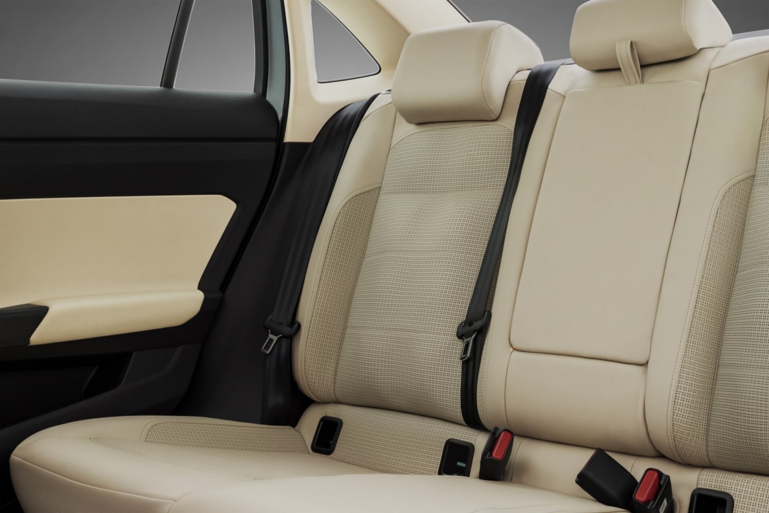 Beige perforated leather rear seats with black seatbelts and integrated headrests