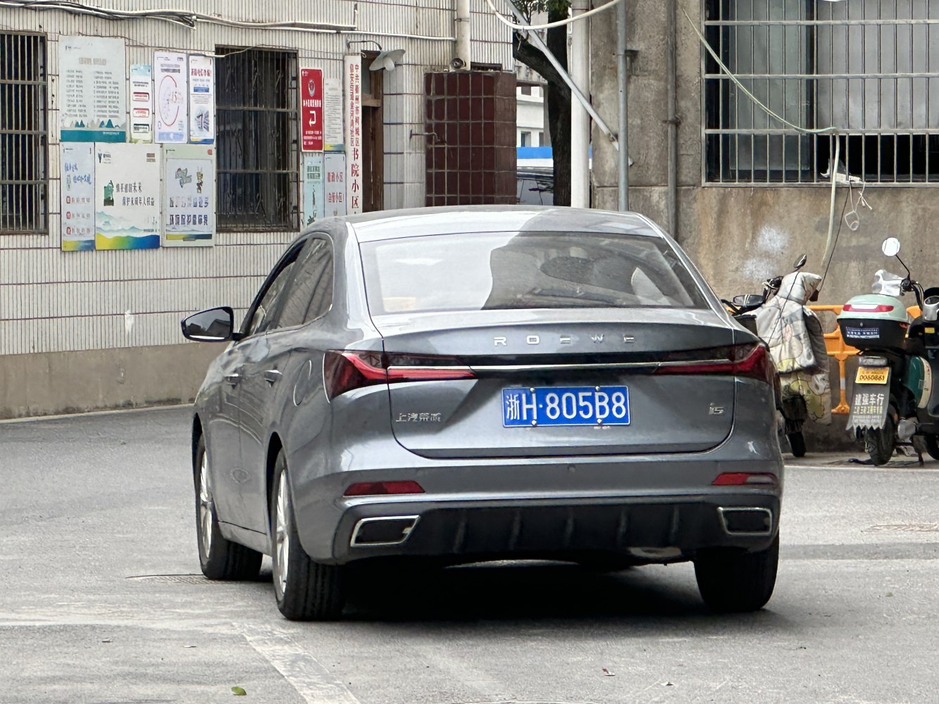 Rear view of sedan with sleek LED tail lights and dual exhaust outlets.