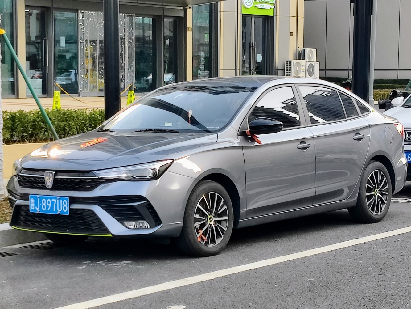 Front and side view of modern sedan with alloy wheels