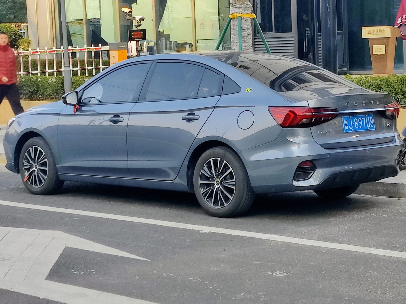 Rear side view of a sedan with tinted windows and alloy wheels