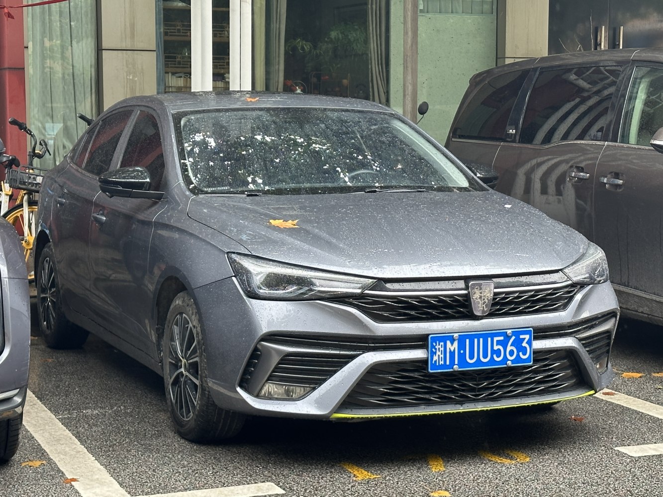 Front view with sharp headlights and distinctive grille of a sedan.