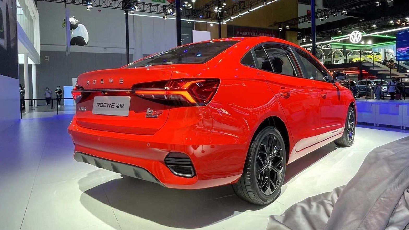 Sleek rear and modern taillights of a red sedan with sporty wheels