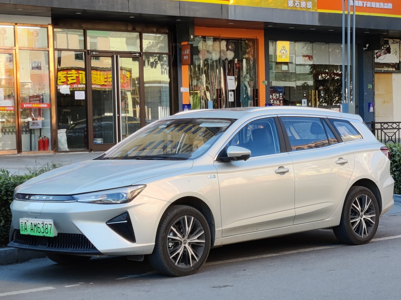 Modern electric station wagon with sharp LED headlights and aerodynamic front design