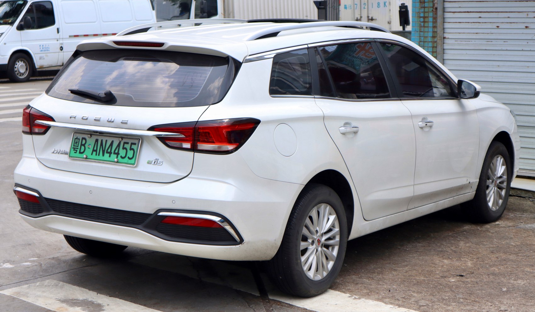 Rear view with split tail lights, roof rails, and windshield wiper