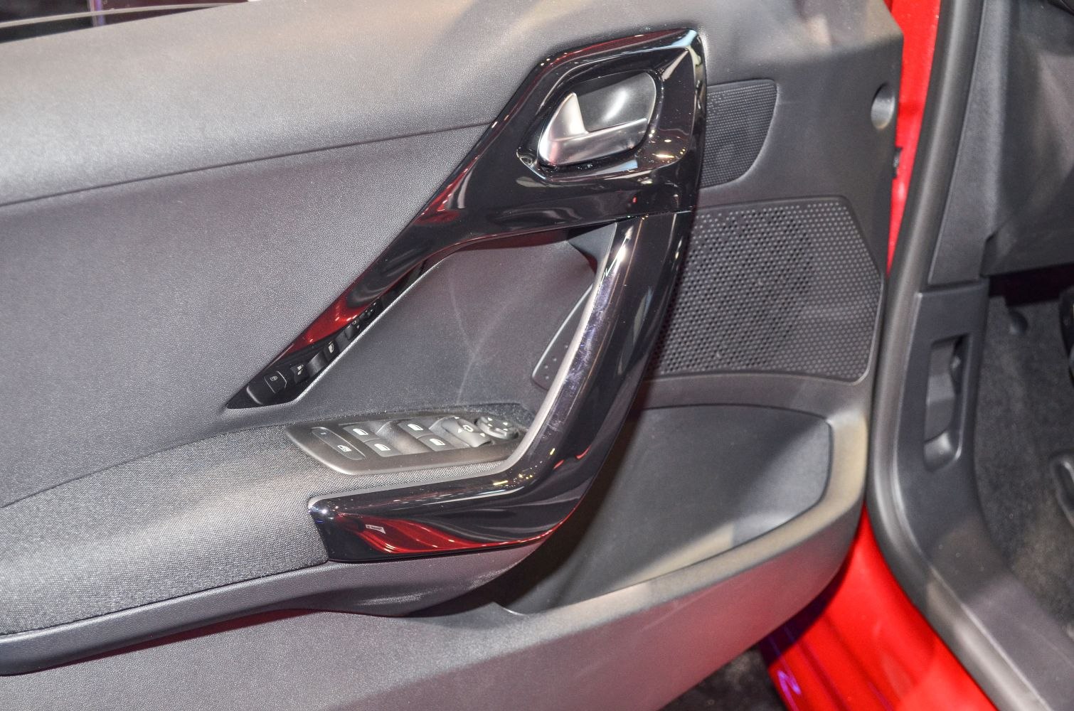 Car interior door panel with control buttons and sleek handle trim