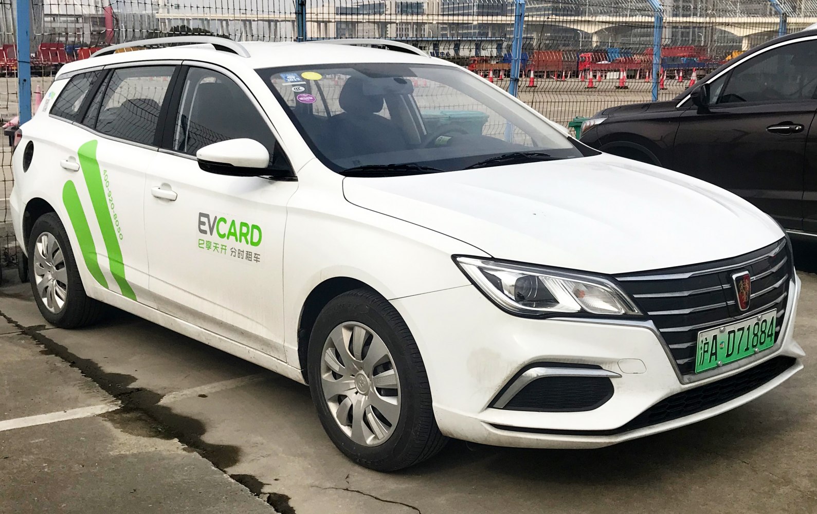 White electric station wagon front-left view with EV card branding