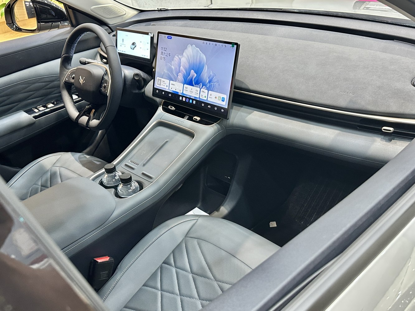 Dual digital displays and quilted leather seats in a modern car interior