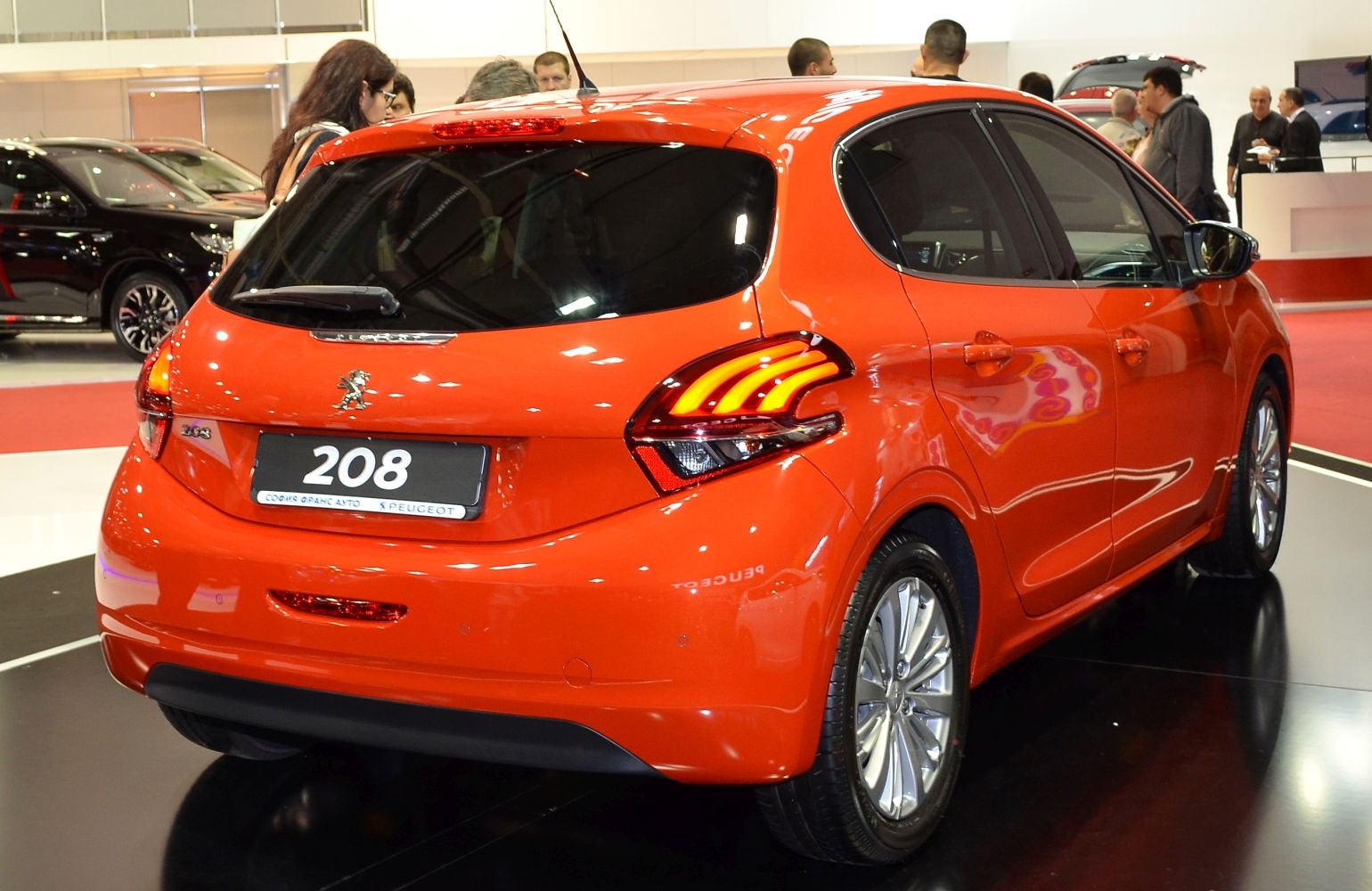 Rear view of a hatchback with distinctive tail lights and glossy paint.
