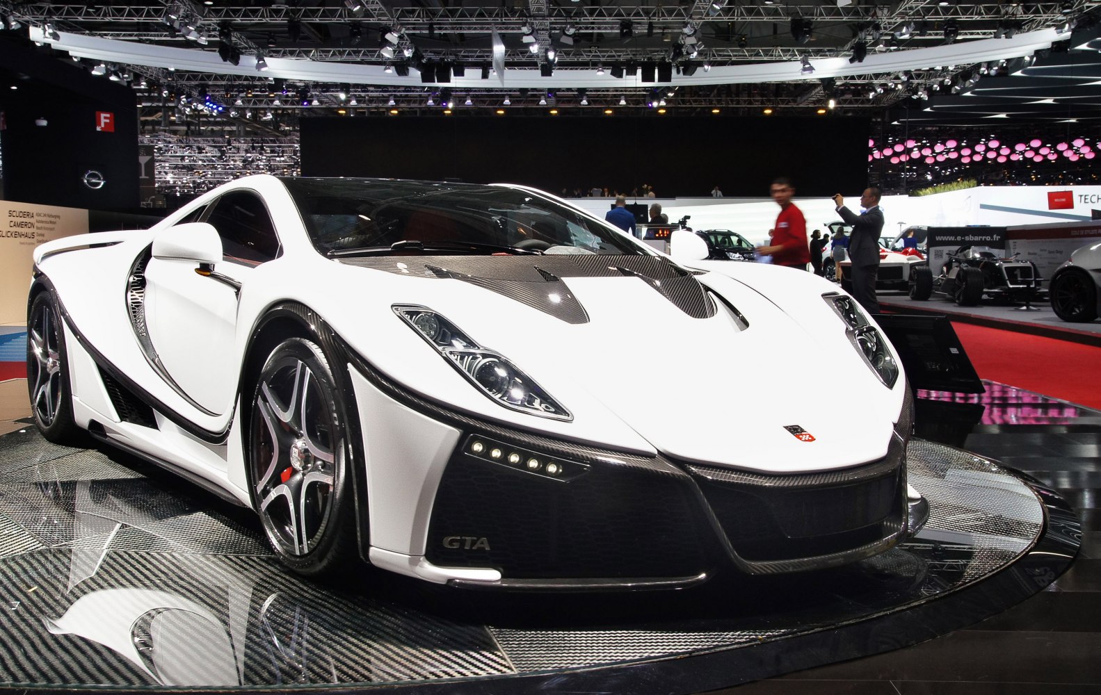 White supercar with carbon fiber elements and aerodynamic shape