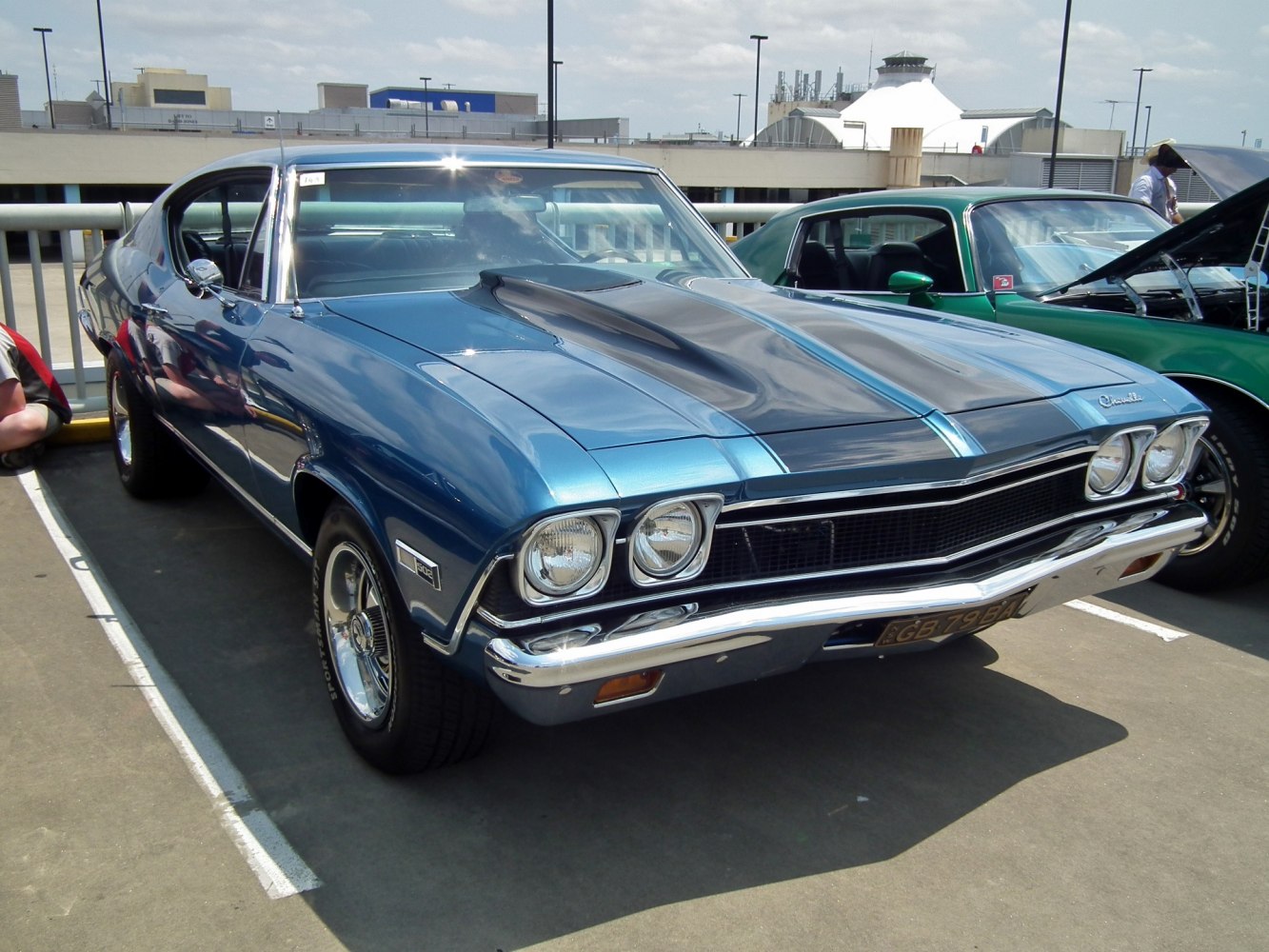 Muscle car front with dual headlights and prominent hood scoop