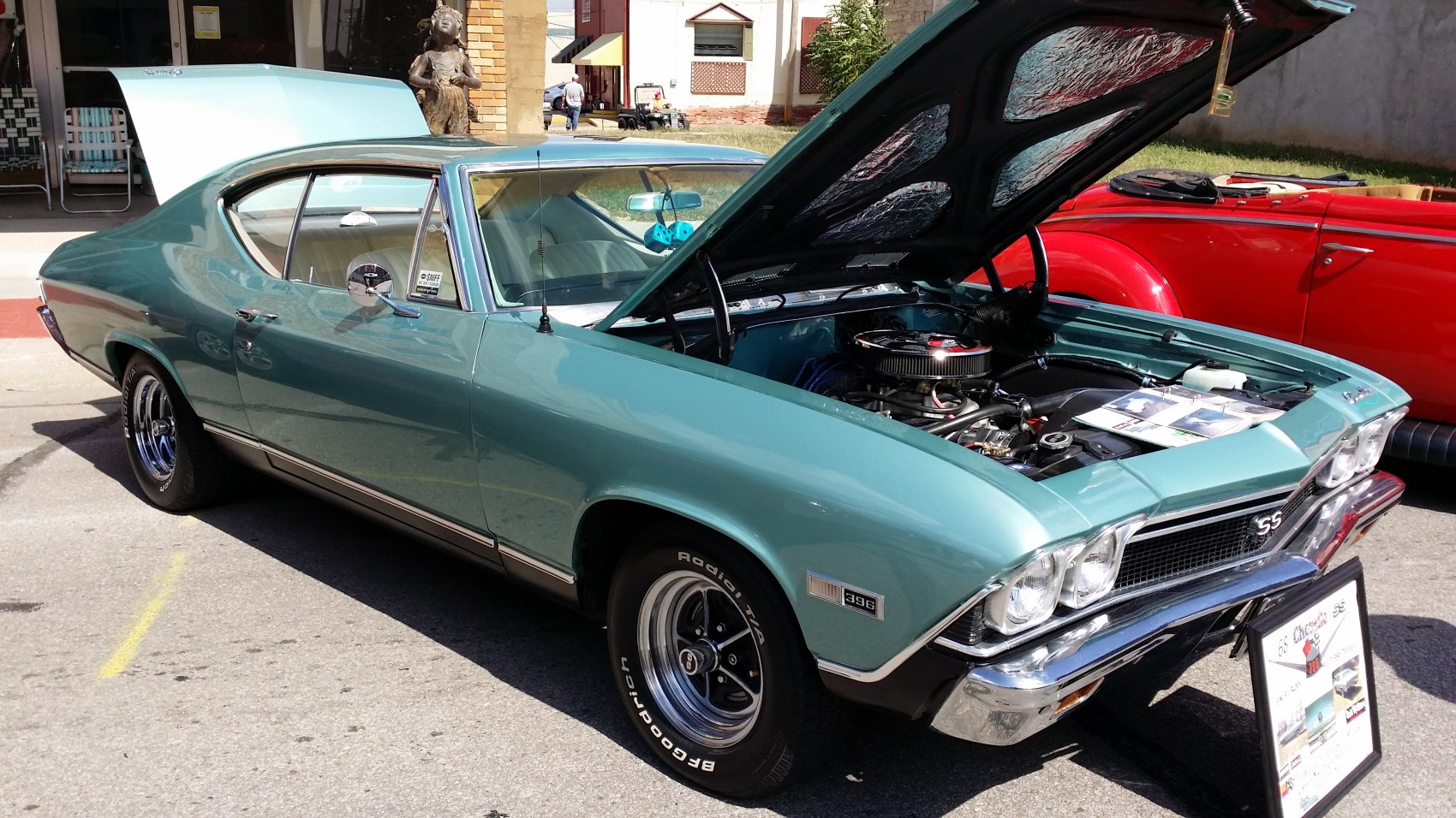 Vintage muscle coupe with open hood and 396 badge