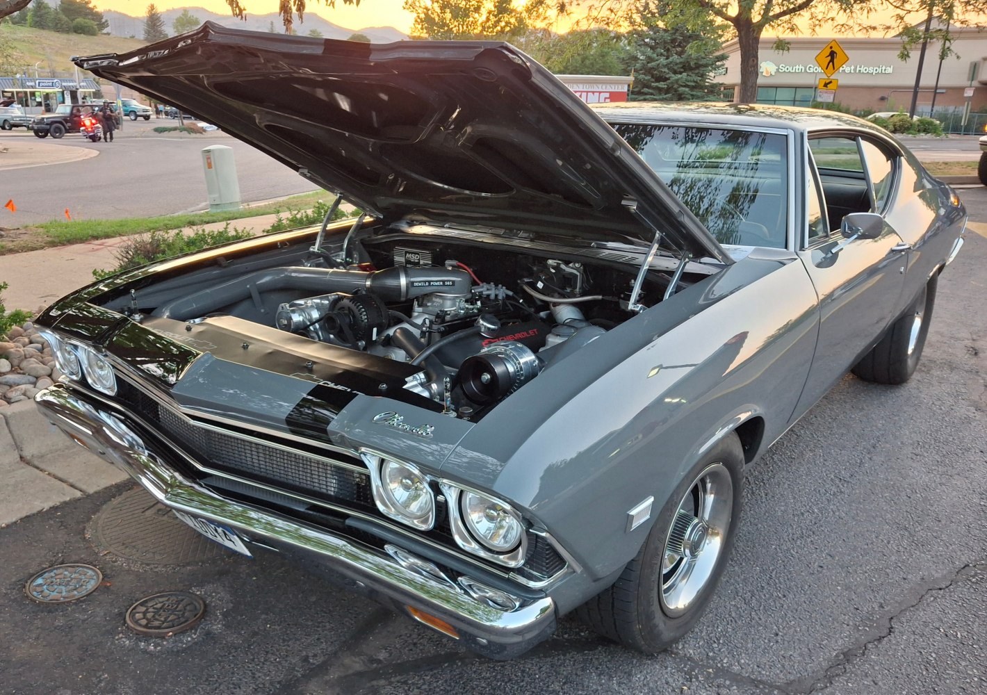 Classic muscle car with open hood revealing detailed engine