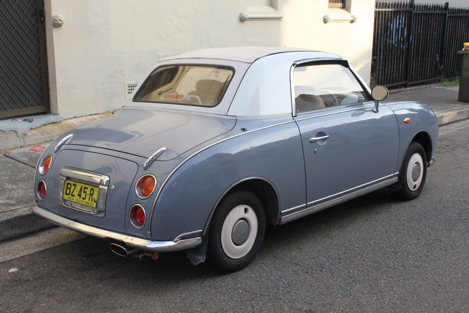 Retro small coupe with round tail lights and convertible roof