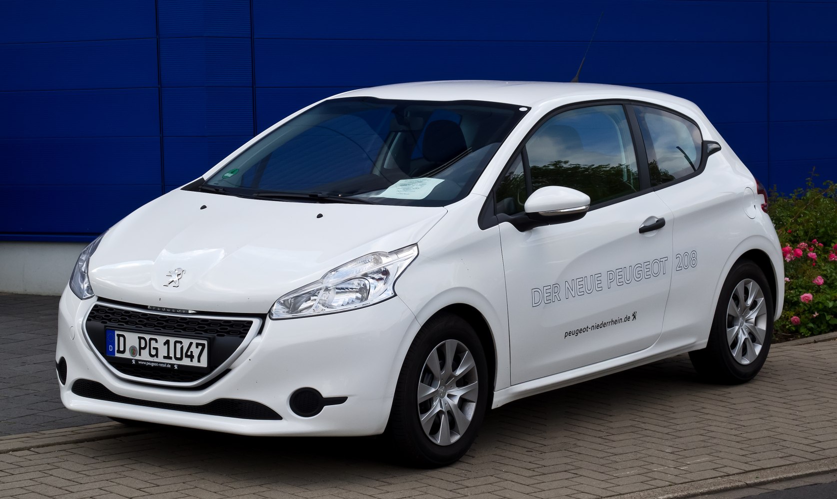 White compact hatchback with bold front grille and sleek headlights