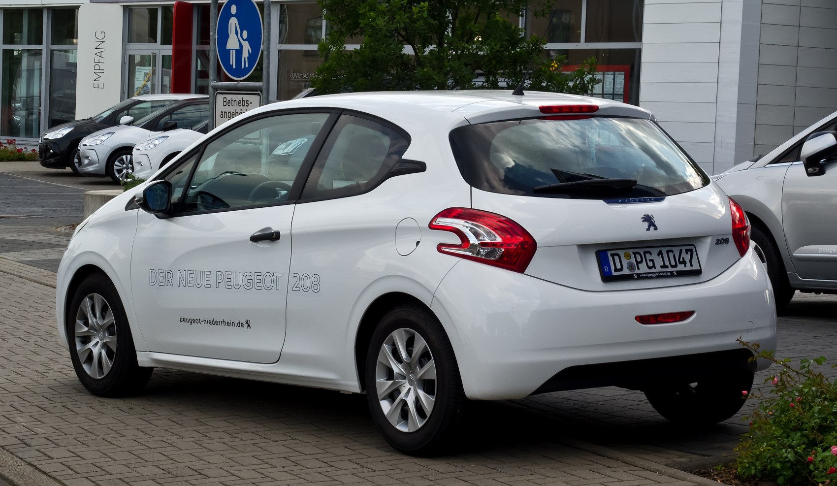 White hatchback rear and side view with distinctive tail lights and smooth body contours