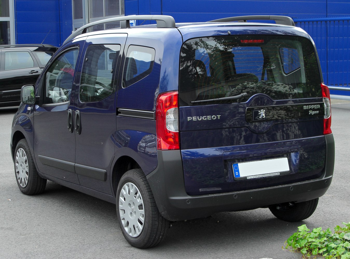 Rear view with sliding doors and compact MPV design