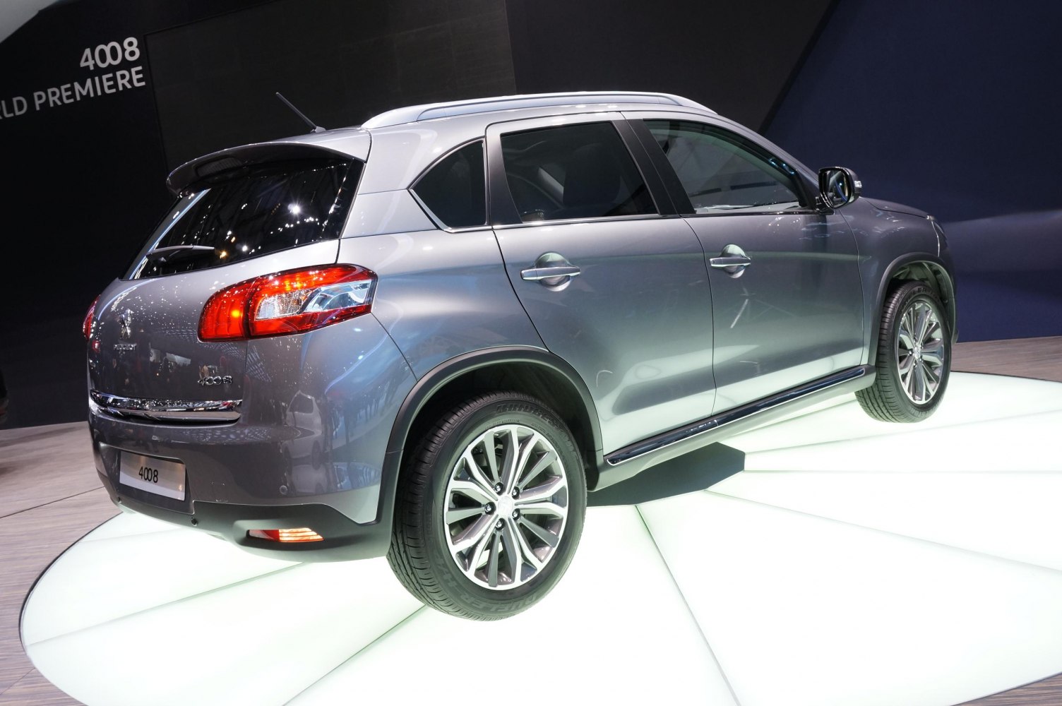 Rear side view of a silver compact SUV with alloy wheels.