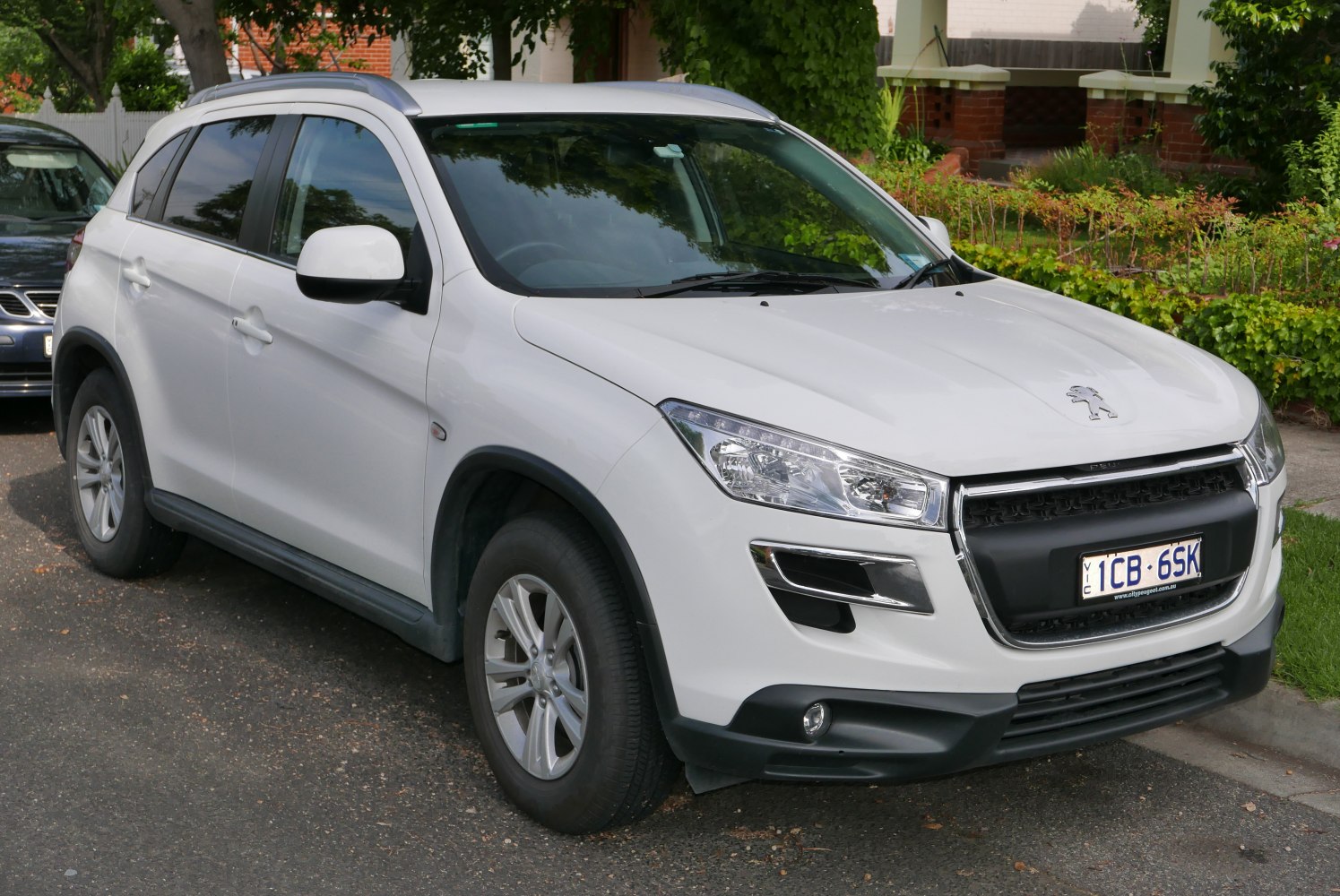 White compact SUV front and side view with distinctive grille and headlights