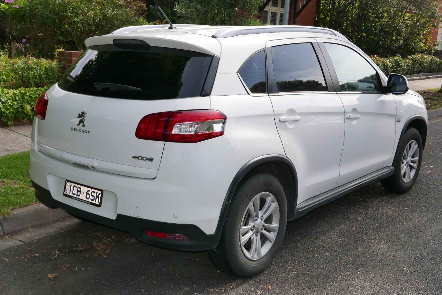 SUV rear-side view with prominent tail lights and tinted windows