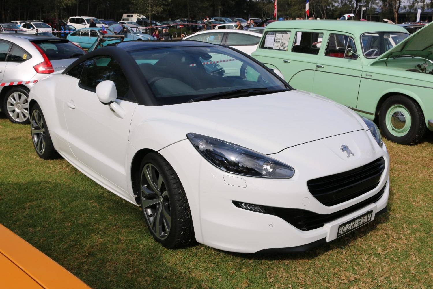 White coupe with sleek headlights and aerodynamic body