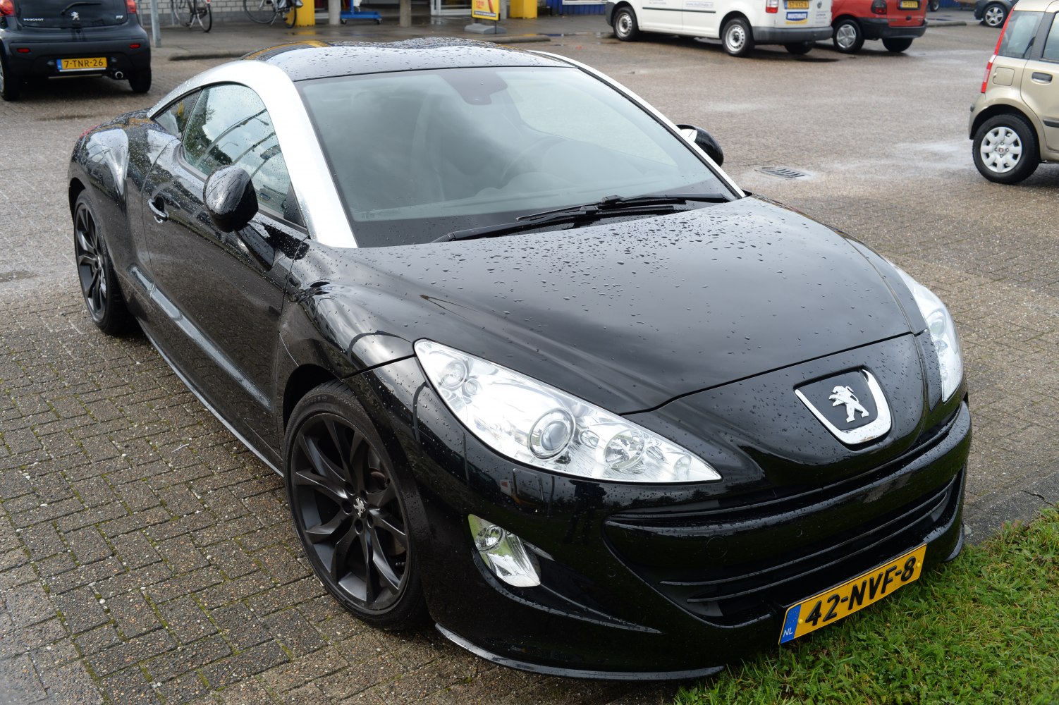 Black sports coupe with silver roof arch and sporty wheels