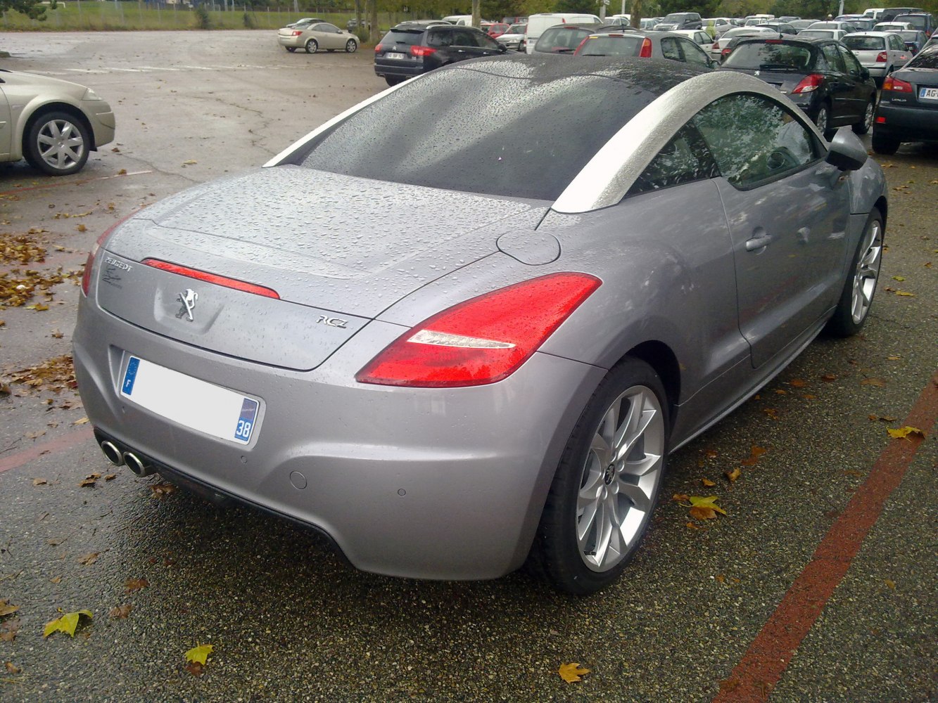 Rear view with dual exhaust, silver roof arch, and sporty taillights