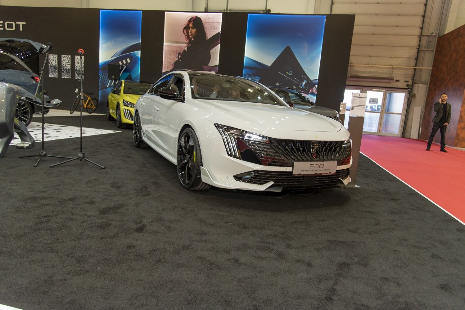 White car front with sleek headlights and aggressive grille