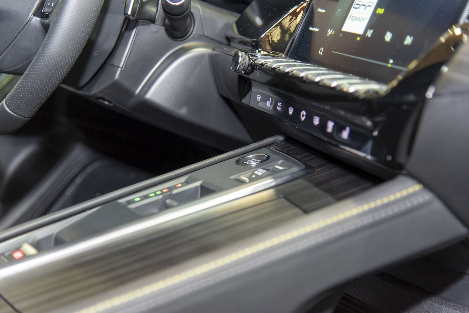 Start-stop button and touch-sensitive controls on car interior console