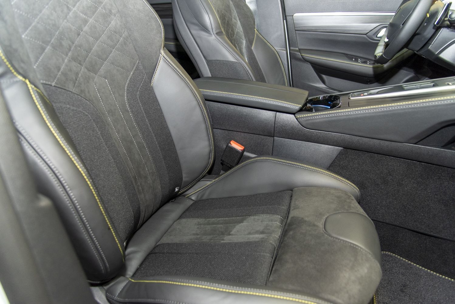 Luxury front seats with suede and leather upholstery and yellow contrast stitching