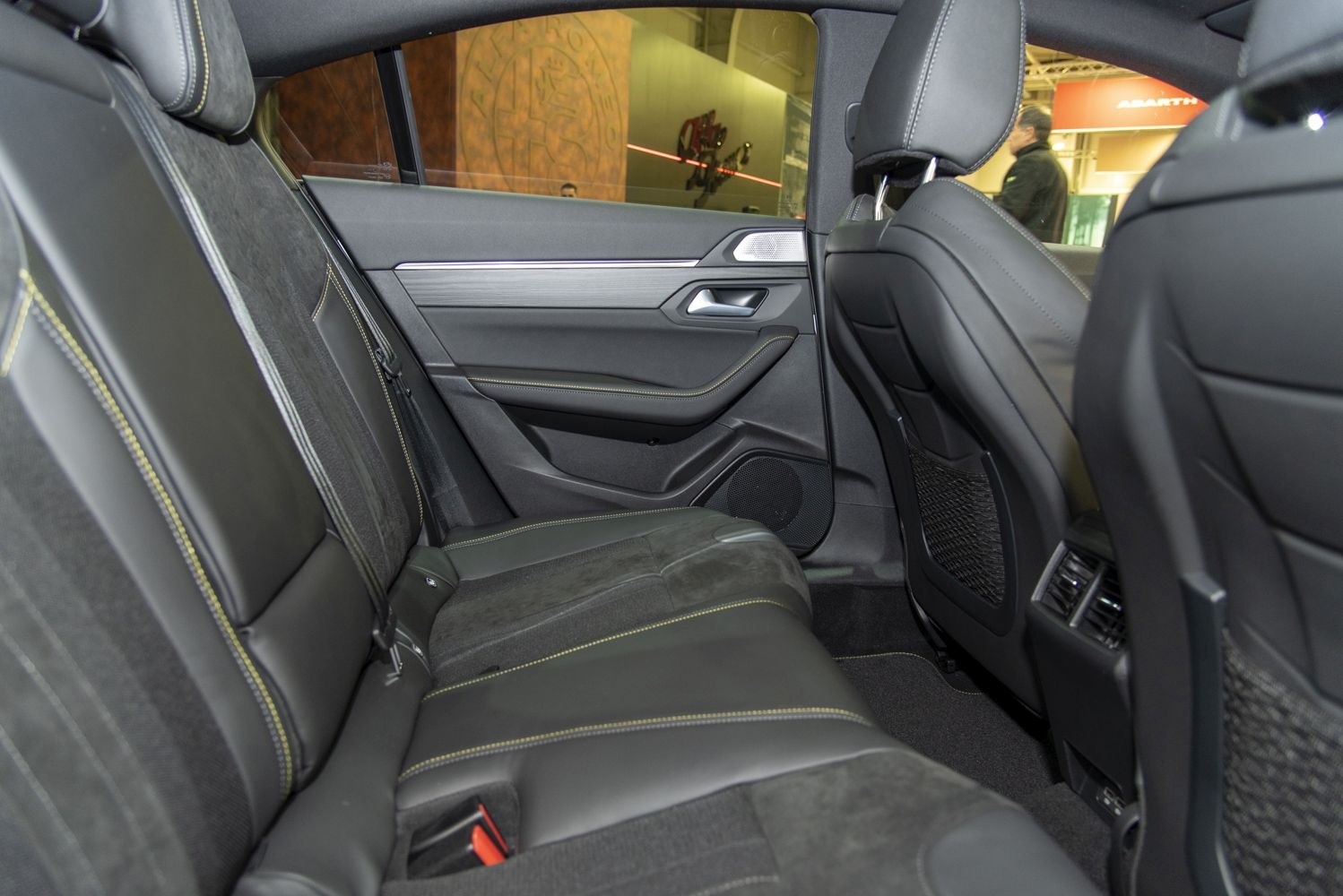 Rear passenger seat with black leather and detailed stitching