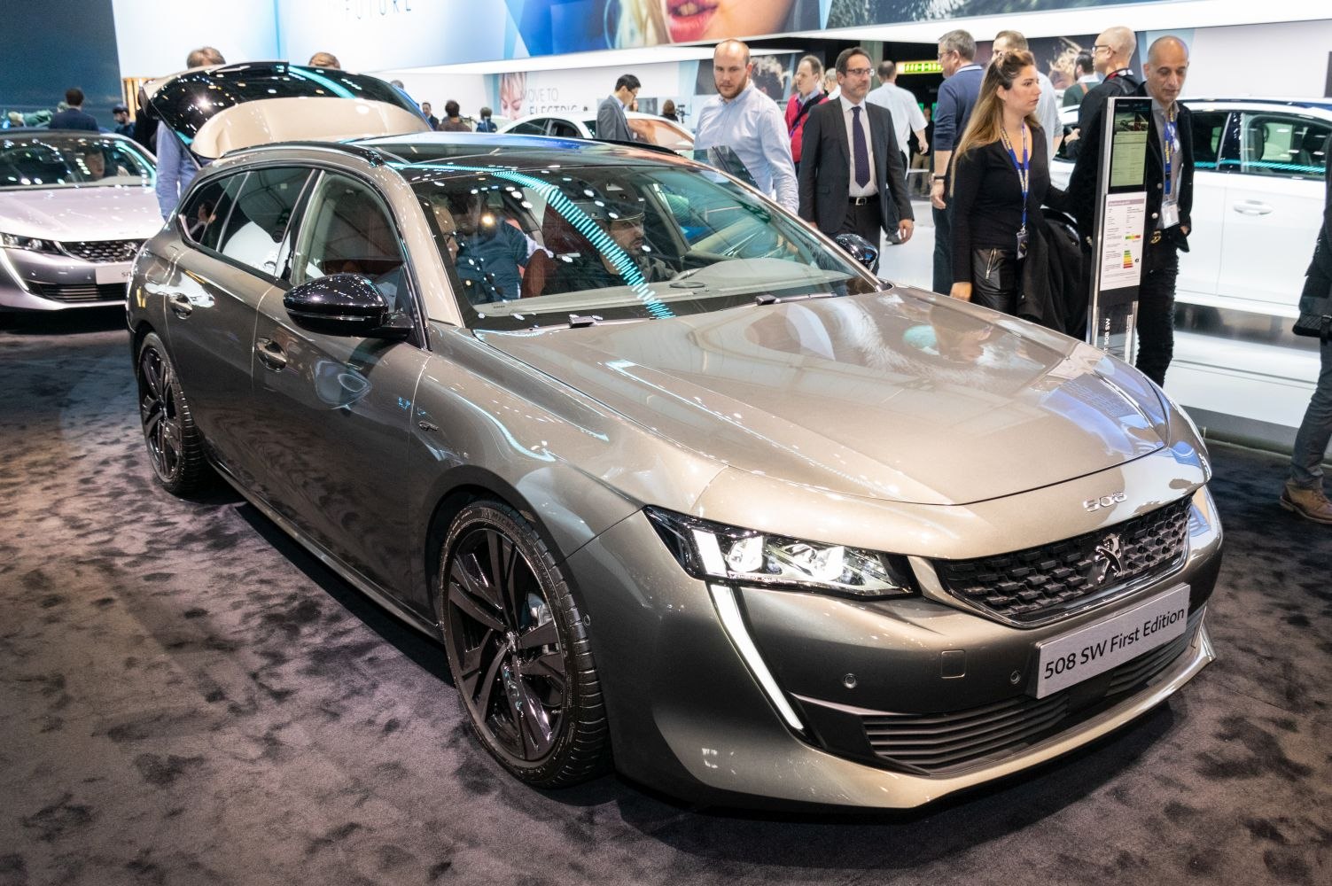Front-side view of a sleek, modern station wagon with LED headlights and sharp body lines.