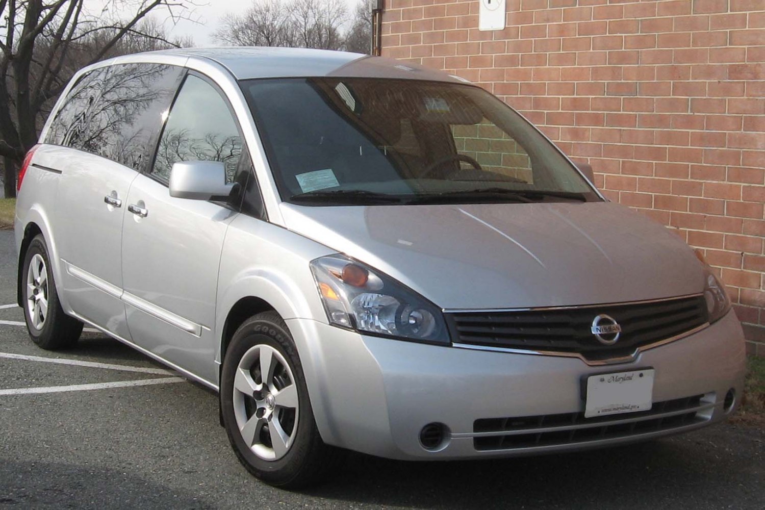 Silver minivan front side with distinctive headlights and alloy wheels