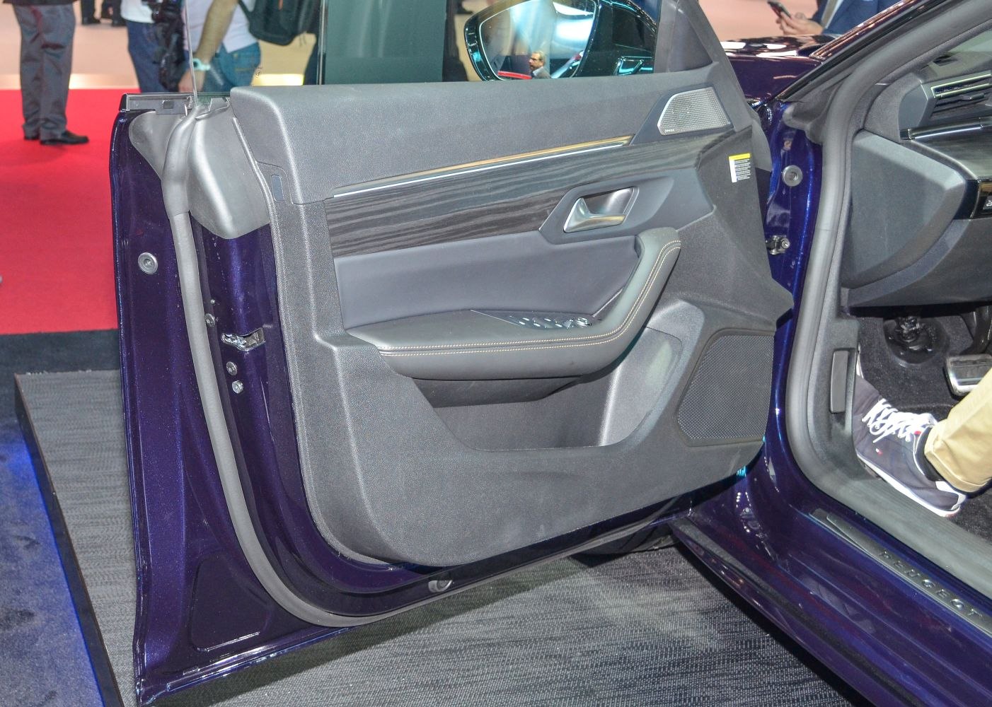 Front door interior panel with window controls and leather armrest