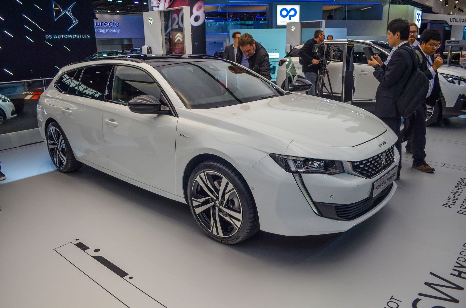 White station wagon with hybrid badge and alloy wheels front-side view