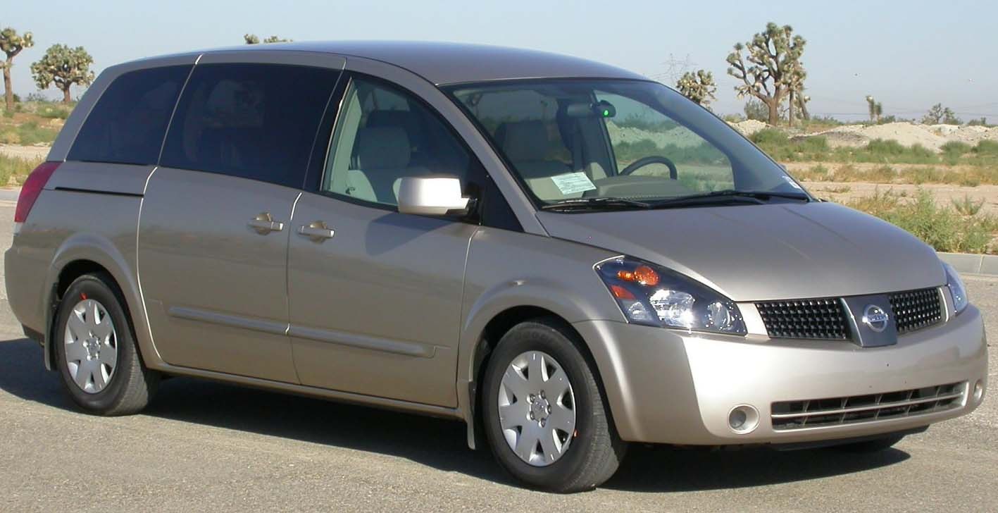 Front side view of a 2004 minivan with tinted windows and sliding doors
