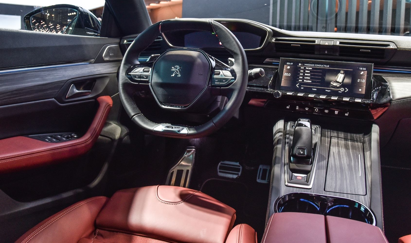 Digital dashboard and touchscreen multimedia center with sleek steering wheel and red leather trim
