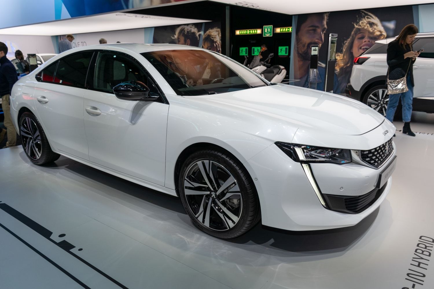 Modern white sedan with sharp headlights and alloy wheels