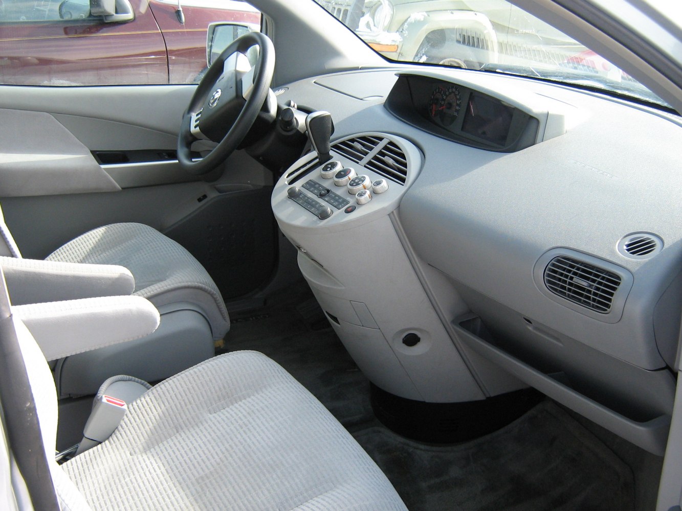 Dashboard with central control panel and grey front seats