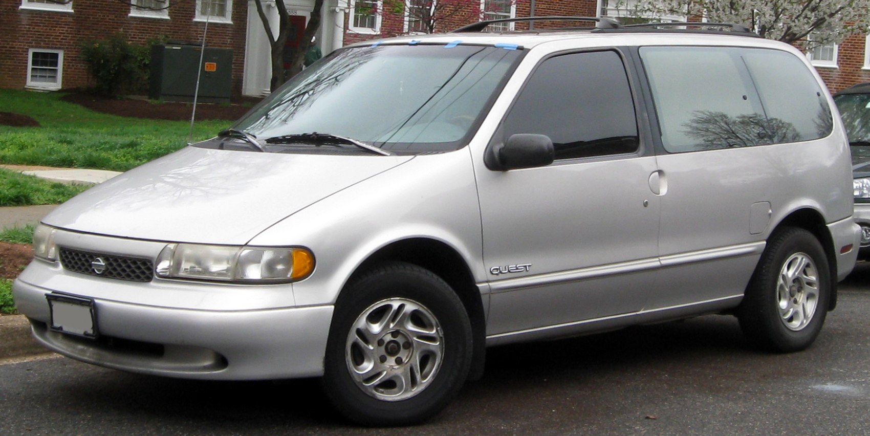 Side view of a silver minivan with rounded design and alloy wheels